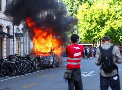 protesters set tesla ablaze smash un office s windows in geneva anti g7 march protesters set tesla ablaze smash un office s windows in geneva anti g7 march