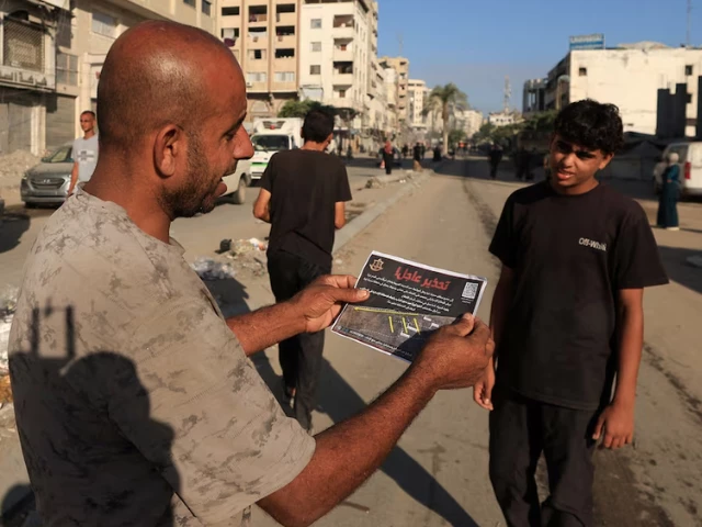 a palestinian man holds a leaflet dropped by israeli forces ordering residents of gaza city to evacuate in gaza city september 9 2025 photo reuters