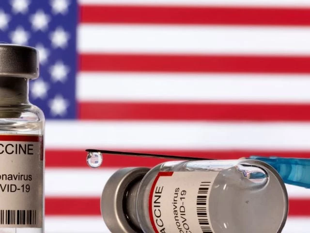vials labelled vaccine coronavirus covid 19 and a syringe are seen in front of a displayed u s flag in this illustration taken december 11 2021 photo reuters vials labelled vaccine coronavirus covid 19 and a syringe are seen in front of a displayed u s flag in this illustration taken december 11 2021 photo reuters