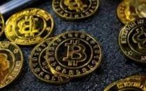 bitcoin coins are seen at a stand during the bitcoin conference 2023 in miami beach florida u s may 19 2023 photo reuters