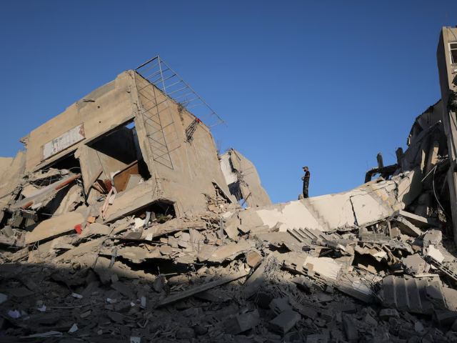 A Palestinian stands at the site of a collapsed residential building hit in an overnight Israeli airstrike, in Gaza City, September 9, 2025. Photo: Reuters