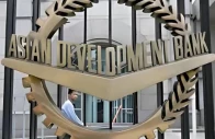 a worker walks past inside the asian development bank adb headquarters in manila photo reuters file