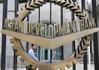 a worker walks past inside the asian development bank adb headquarters in manila photo reuters file
