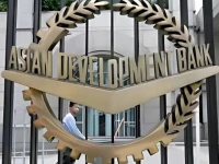 a worker walks past inside the asian development bank adb headquarters in manila photo reuters file