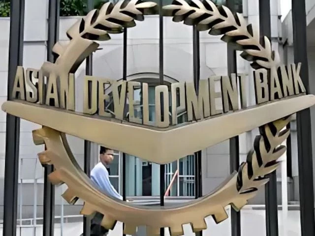 a worker walks past inside the asian development bank adb headquarters in manila june 17 2009 photo reuters
