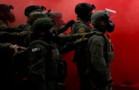 law enforcement officers stand amid smoke from a smoke grenade released to disperse demonstrators in front of the us immigration and customs enforcement ice headquarters in portland oregon u s october 4 2025 photo reuters