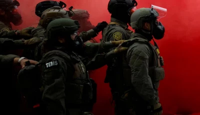 law enforcement officers stand amid smoke from a smoke grenade released to disperse demonstrators in front of the us immigration and customs enforcement ice headquarters in portland oregon u s october 4 2025 photo reuters