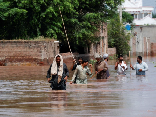 residents wade through a flooded road following monsoon rains and rising water levels in qadirabad village near the chenab river in punjab province pakistan august 28 2025 photo reuters residents wade through a flooded road following monsoon rains and rising water levels in qadirabad village near the chenab river in punjab province pakistan august 28 2025 photo reuters