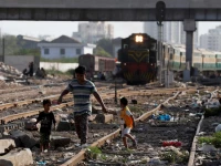 siblings walk along a railway tracks at a slum area in karachi pakistan july 9 2020 photo reuters