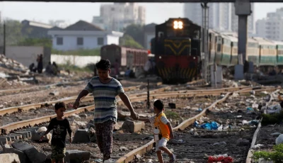 siblings walk along a railway tracks at a slum area in karachi pakistan july 9 2020 photo reuters