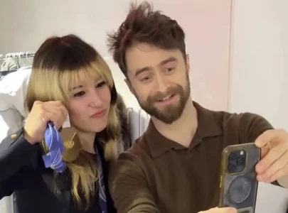 alysa liu and daniel radcliffe share playful gold medal moment backstage at today alysa liu and daniel radcliffe share playful gold medal moment backstage at today