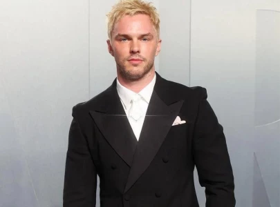 nicholas hoult returns to bleached blond hair steps out with wife bryana holly at vanity fair oscar party