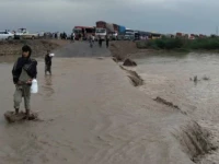 the busy national highway from zhob to dera ismail khan experienced a flood late sunday night stranding hundereds of passengers photo express