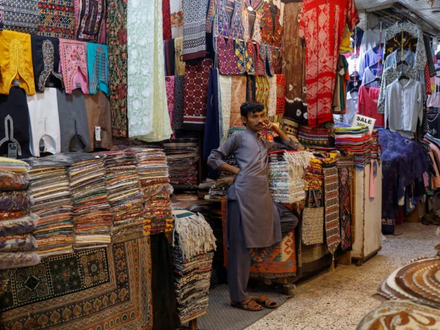 a shopkeeper stands outside his shop while waiting for customers ahead of eid al fitr celebrations in karachi pakistan april 19 2023 photo reuters a shopkeeper stands outside his shop while waiting for customers ahead of eid al fitr celebrations in karachi pakistan april 19 2023 photo reuters