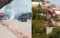 two vehicles torched as cda anti encroachment drive sparks protest in capital two vehicles torched as cda anti encroachment drive sparks protest in capital