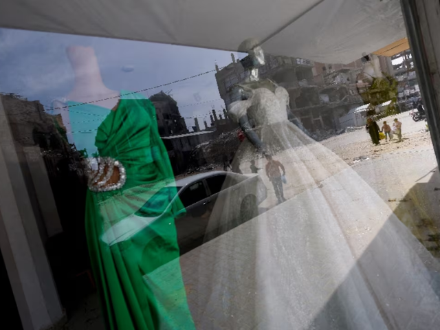 Photo: Wedding dresses are displayed at a shop, as brides in Gaza turn to reused gowns/Reuters