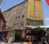 photo street vendors gather outside the faded facade of the granada cinema central baghdad afp photo street vendors gather outside the faded facade of the granada cinema central baghdad afp