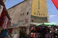 photo street vendors gather outside the faded facade of the granada cinema central baghdad afp