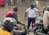 a traffic police officer redirects traffic as heavy monsoon rains lash lahore for the second day photo express a traffic police officer redirects traffic as heavy monsoon rains lash lahore for the second day photo express