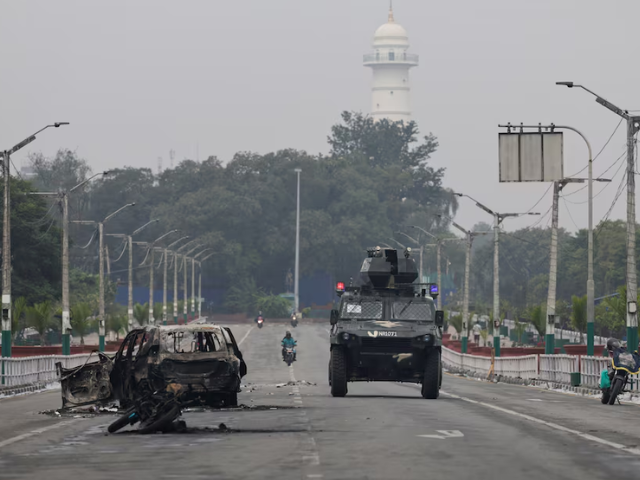 A military vehicle moves past a burnt vehicle on a road near the Singha Durbar office complex that houses the Prime Minister's office and other ministries, following protests against Monday's killing of 19 people after anti-corruption protests triggered by a social media ban which was later lifted, in Kathmandu, Nepal, September 10, 2025. Photo: Reuters
