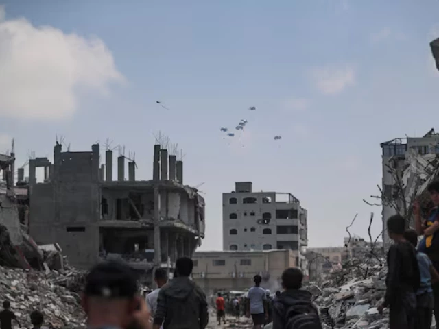 palestinians look at aid packages that are airdropped over gaza in gaza city august 8 2025 reuters