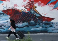 an iranian woman walks next to a mural on a street in tehran iran may 11 2026 photo reuters an iranian woman walks next to a mural on a street in tehran iran may 11 2026 photo reuters