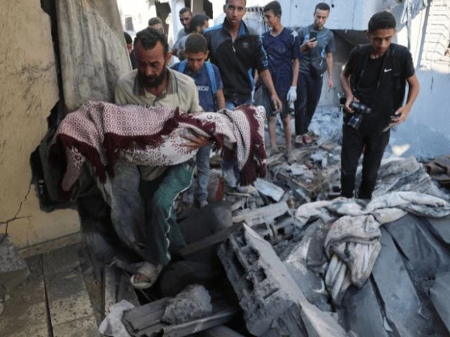 a palestinian man carries the body of a child killed in an overnight israeli air strike on a house at the site of the strike in gaza city on july 23 2025 reuter a palestinian man carries the body of a child killed in an overnight israeli air strike on a house at the site of the strike in gaza city on july 23 2025 reuter