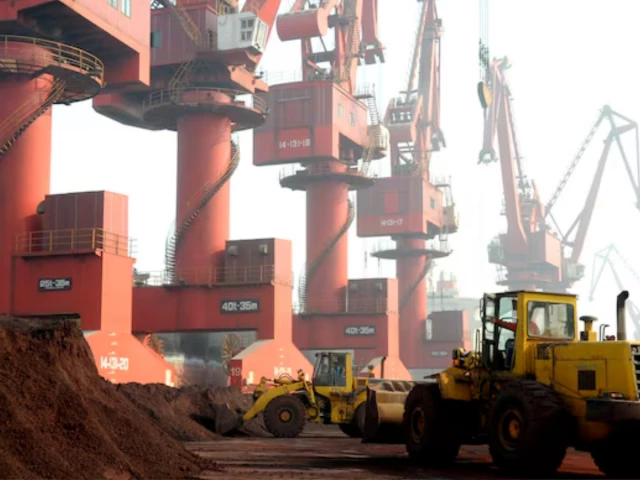 workers transport soil containing rare earth elements for export at a port in lianyungang jiangsu province china october 31 2010 picture taken october 31 2010 photo reuters