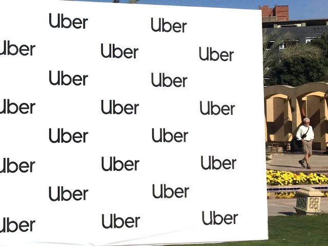 a man walks near a banner of ride sharing app uber during a news conference in cairo egypt december 4 2018 photo reuter a man walks near a banner of ride sharing app uber during a news conference in cairo egypt december 4 2018 photo reuter