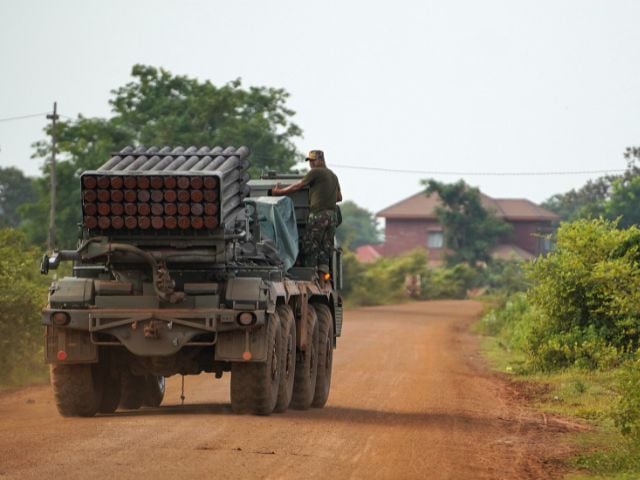 A Cambodian military personnel gestures from a BM-21 Grad multiple rocket launcher, around 40 km (24 miles) from the disputed Ta Moan Thom temple, after Thailand and Cambodia exchanged heavy artillery on Friday as their worst fighting in more than a decade stretched for a second day, in Oddar Meanchey province, Cambodia, July 25, 2025. REUTERS/Soveit Yarn