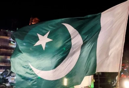 people wave national flags as they gather on the eve of independence day in lahore on august 13 2025 photo reuters