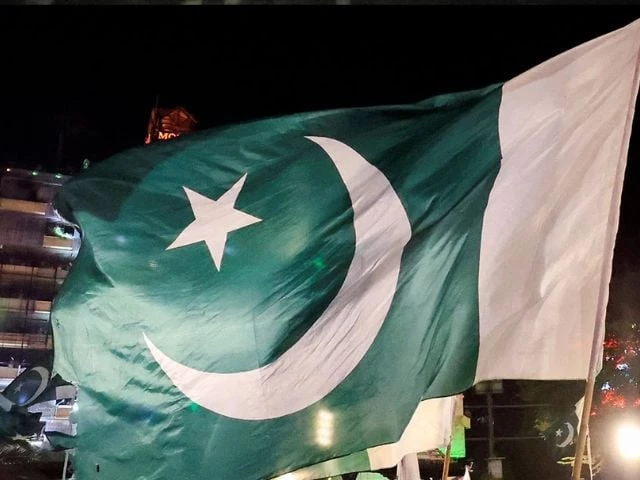 people wave national flags as they gather on the eve of independence day in lahore on august 13 2025 photo reuters