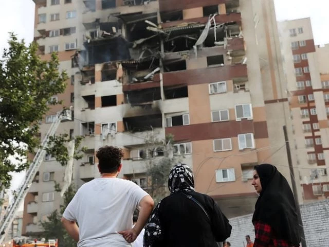 photo people look at a damaged building in tehran iran june 13 2025 majid asgaripour reuters photo people look at a damaged building in tehran iran june 13 2025 majid asgaripour reuters