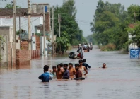 residents wade through a flooded road following monsoon rains and rising water levels in qadirabad village near the chenab river in punjab province pakistan august 28 2025 photo reuters