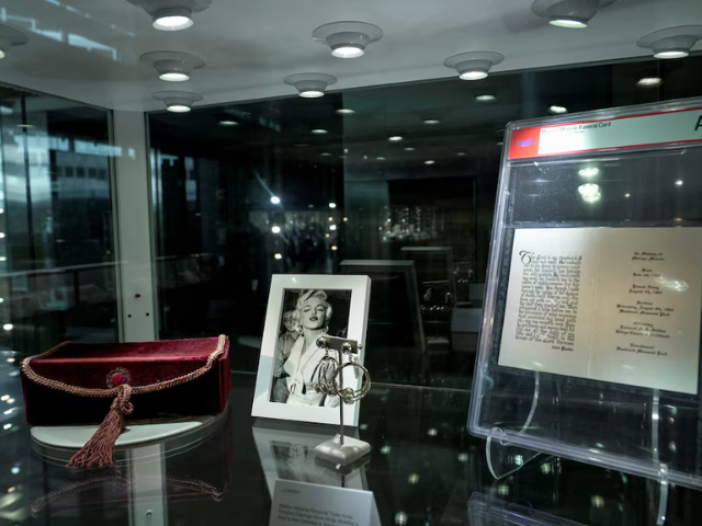 Screengrab of movie star Marilyn Monroe is displayed alongside a photograph during a preview ahead of an upcoming auction in Los Angeles/Reuters