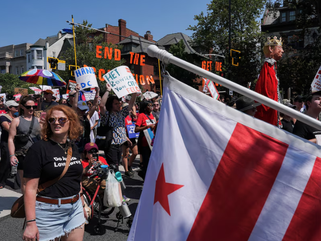 Demonstrators attend the 
