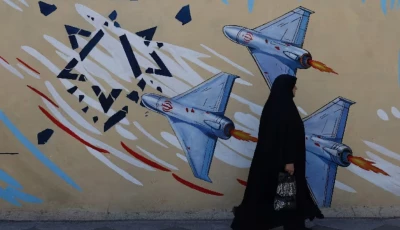 an iranian woman walks next to an anti israeli mural on a street in tehran iran may 18 2026 photo reuters