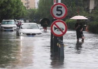 people wade through a flooded street after typhoon dolphin brought heavy rain to shanghai china august 10 2026 photo reuters