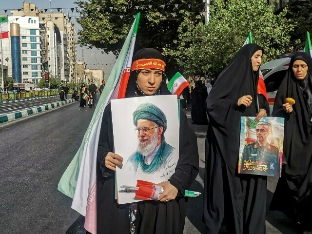 Mourners carry national flags and portraits of Iran’s supreme leader Ayatollah Ali Khamenei (C) and slain Iranian Armed Forces Chief of Staff, Major General Mohammad Bagheri (R), during the funeral procession of military commanders and civilians killed during Israeli strikes on the first day of the war, near Enqelab Square in Tehran on June 28, 2025. — AFP