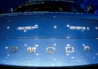 a logo of chery s brand omoda appears on a car as people sit inside at the company s booth at the beijing international automotive exhibition auto china in beijing april 24 2026 photo reuters