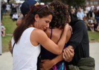 people embrace as they visit a makeshift memorial following the attack on a jewish holiday celebration at sydney s bondi beach in sydney australia december 15 2025 photo reuters