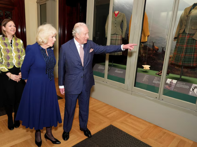 Britain's King Charles and Queen Camilla with Caroline de Guitaut, exhibition curator/REUTERS