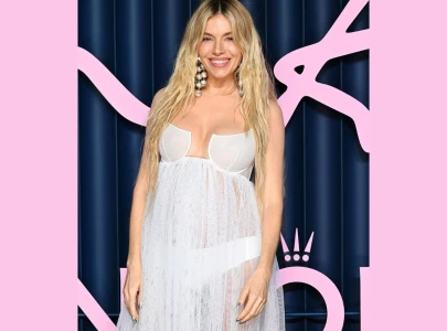 sienna miller debuts baby bump at british fashion week