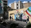 people walk on a street near a mural featuring an image of the late supreme leader of iran ayatollah ali khamenei in tehran iran may 18 2026 photo reuters