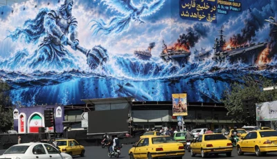 people drive past a billboard about the strait of hormuz on a building in tehran iran september 16 2026 photo anadolu agency