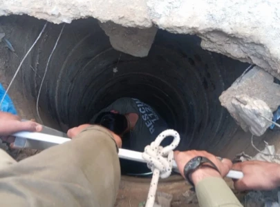 five rescued after falling into open drain in korangi