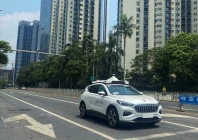 a driverless car by apollo go baidu s robotaxi service drives past another apollo go robotaxi parked on the side of a road in wuhan hubei province china july 19 2024 photo reuters