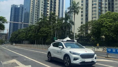 a driverless car by apollo go baidu s robotaxi service drives past another apollo go robotaxi parked on the side of a road in wuhan hubei province china july 19 2024 photo reuters