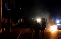 people walk past trash set on fire in the middle of a street during a protest against frequent power cuts as havana faces its worst rolling blackouts in decades amid a u s blockade that has strangled the island of fuel in havana cuba may 13 2026 photo reuters