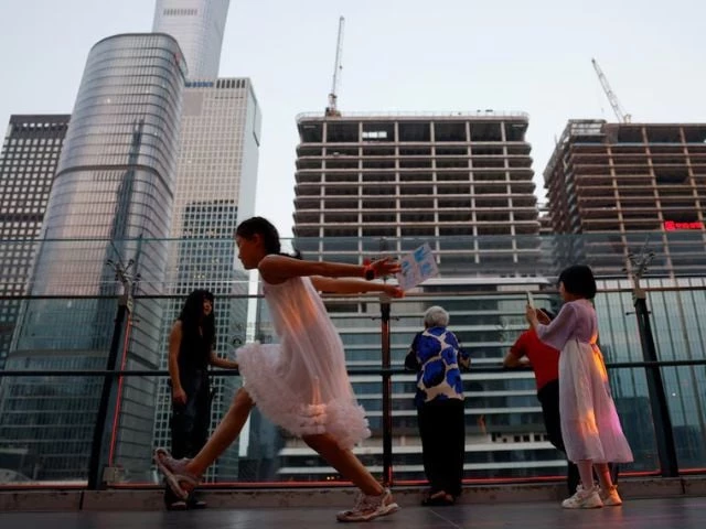 people visit a terrace of a shopping mall overlooking the central business district cbd in beijing china august 11 2025 photo reuters